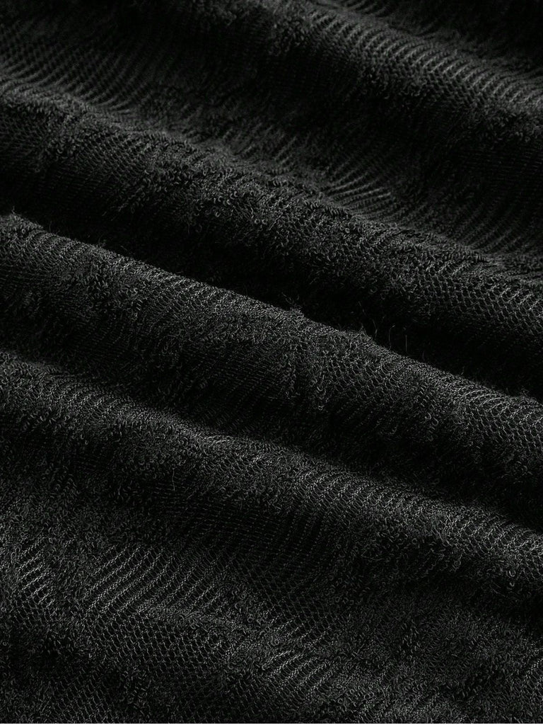 Robe noire en dentelle manches cloche et nœud dans le dos années 1960