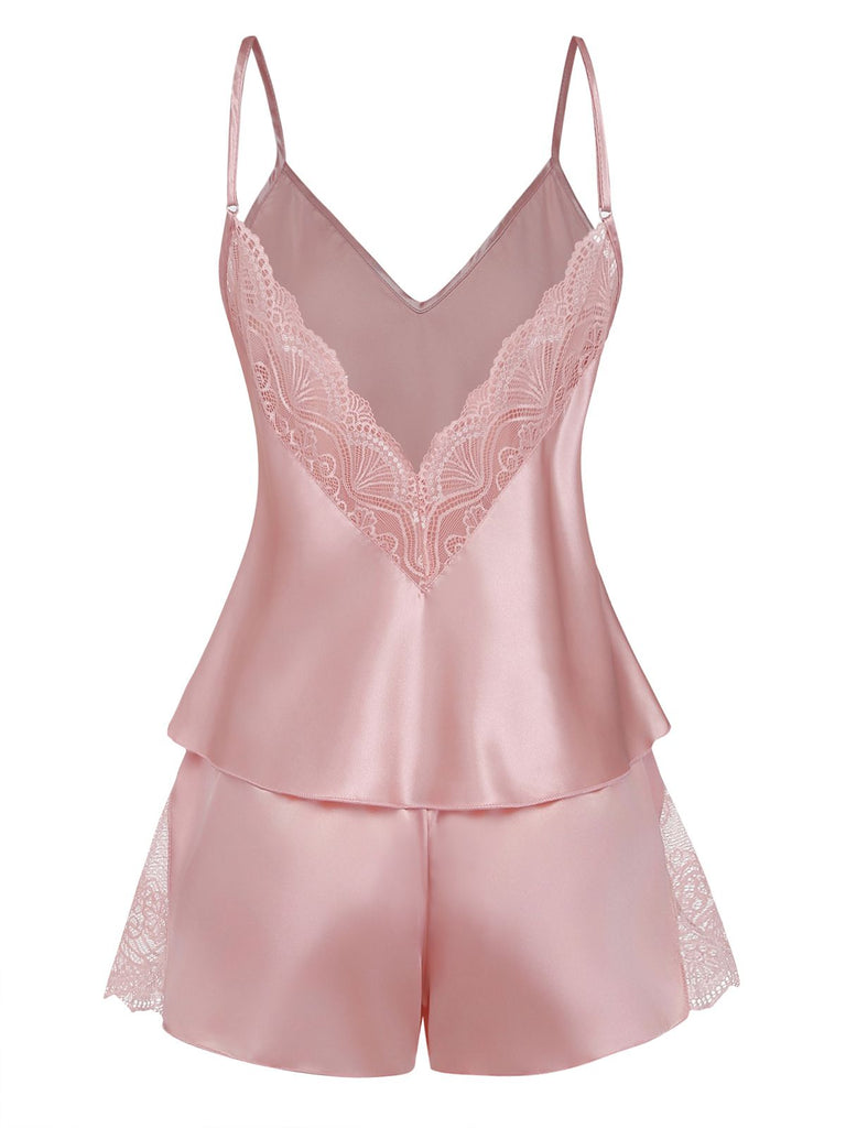 Pink satin pajama set with lace details on a white background
