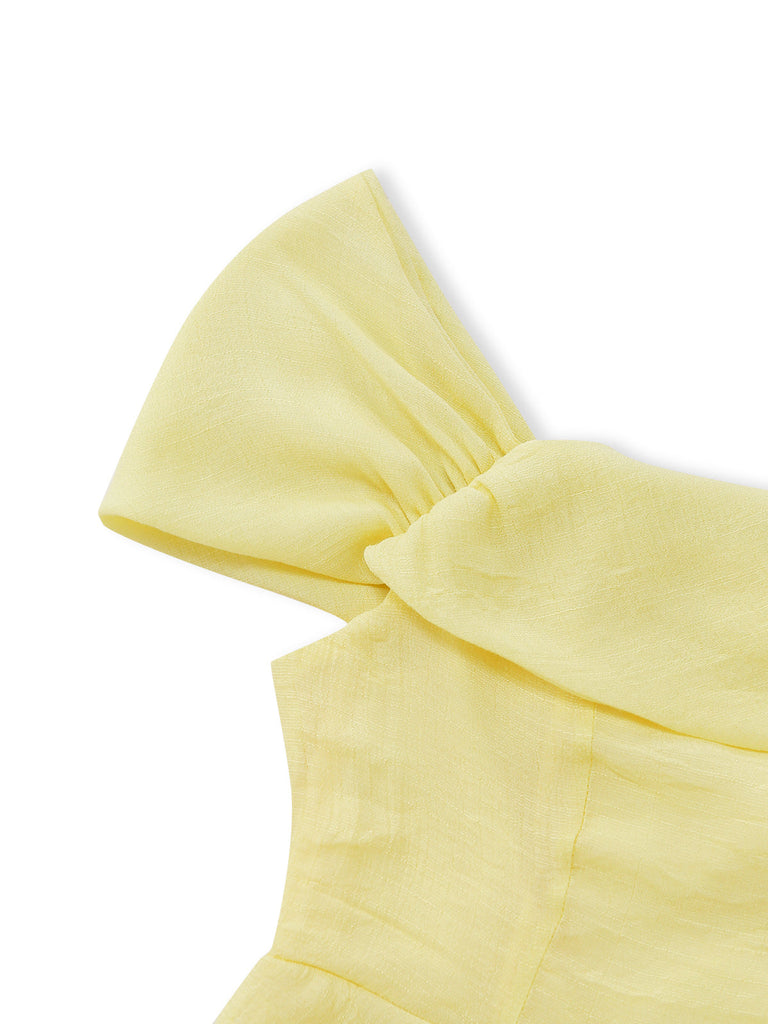 Yellow strapless top with a large bow detail on a white background