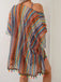 Multicolored striped dress with tassels on a plain background