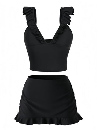 Black two-piece swimsuit with ruffled details on a white background