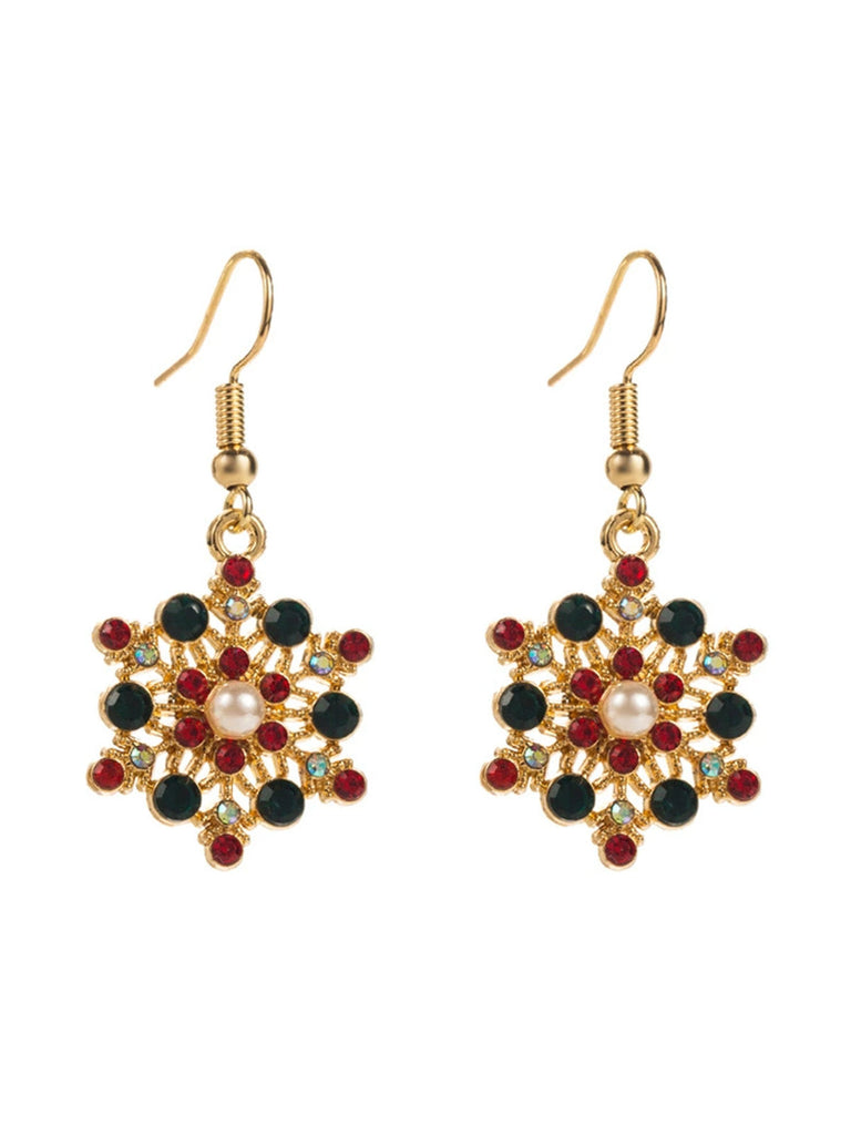 Boucles d'oreilles en strass et chapeau de Noël et un flocon de neige