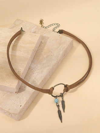 Boucles d'oreilles et collier ras du cou attrape-rĂȘves et plumes