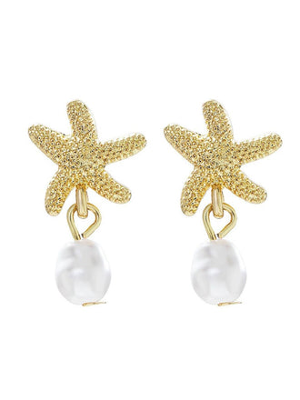 Gold starfish earrings with pearl drops on a white background