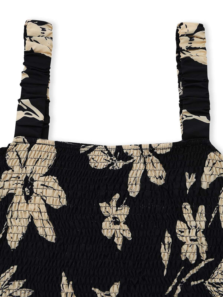 Black floral patterned Romper with straps on a white background