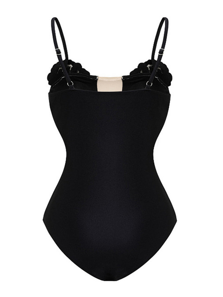 Black swimsuit with thin straps on a white background