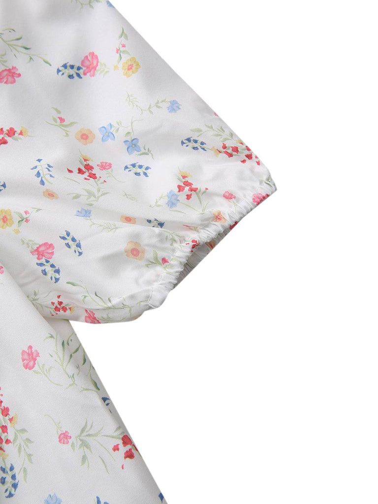 Robe blanche à fleurs col carré et manches bouffantes années 1930