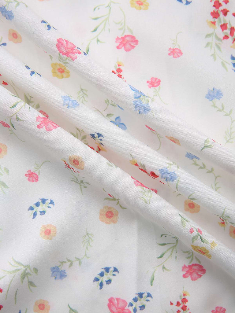 Robe blanche à fleurs col carré et manches bouffantes années 1930