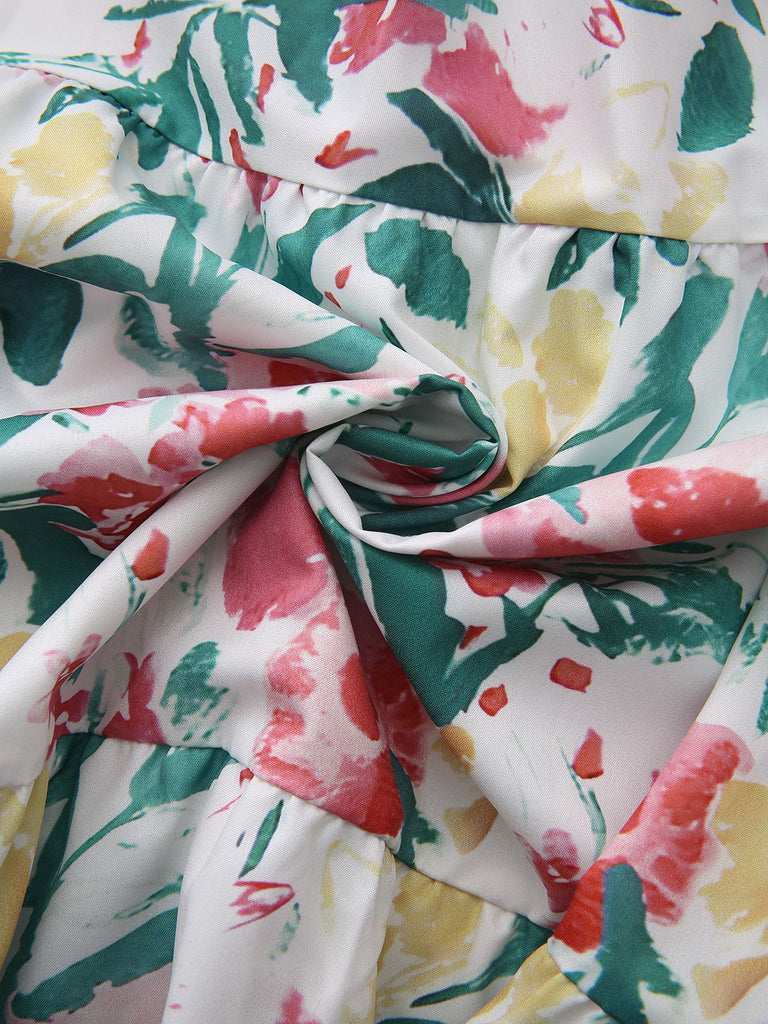 Close-up of colorful floral fabric with green, red, yellow, and pink flowers on a white background.
