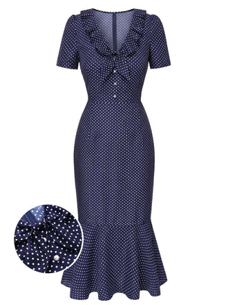 Navy blue dress with white polka dots on a white background