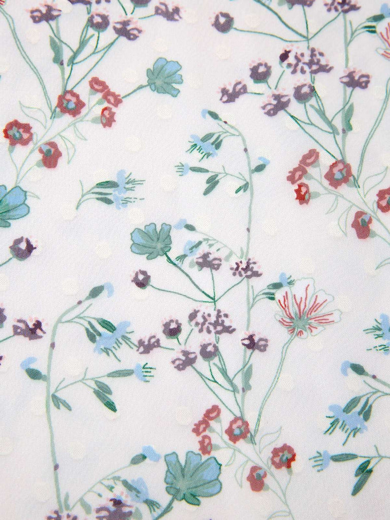 Floral pattern with red, blue, and purple flowers on a white background