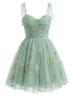 Green floral dress with sheer straps on a white background