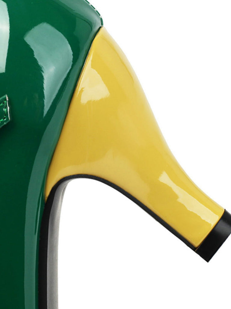 Close-up of a green and yellow high-heeled shoe with a black sole.