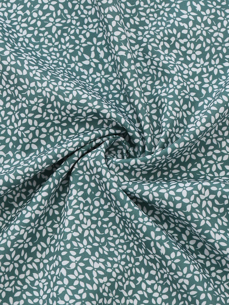 Close-up of green fabric with white floral pattern