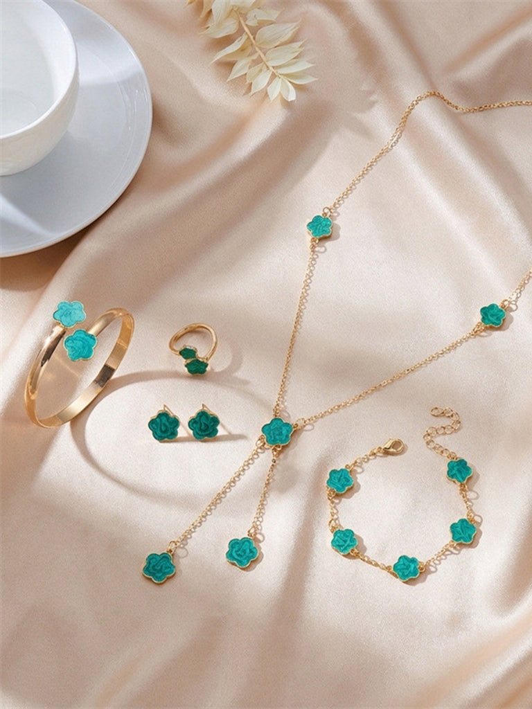 Jewelry set with turquoise stones on a beige fabric background