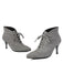 Gray suede ankle boots with lace-up design on a white background