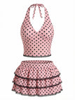 Haut de tankini rose à pois, dos nu, avec jupe de bain à volants, style années 1950, parfait pour la plage et les activités estivales au bord de la piscine.