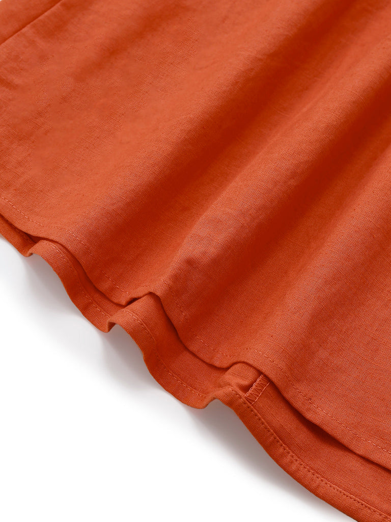 Robe unie orange à col en V et boutons et broche années 1940