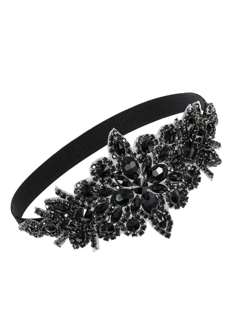 Objet circulaire noir avec la marque « UNIQUE » sur fond blanc