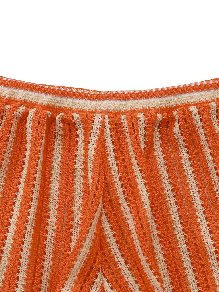 Close-up of orange and beige striped fabric with a frayed edge.