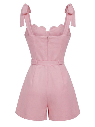Pink romper with bow straps on a white background