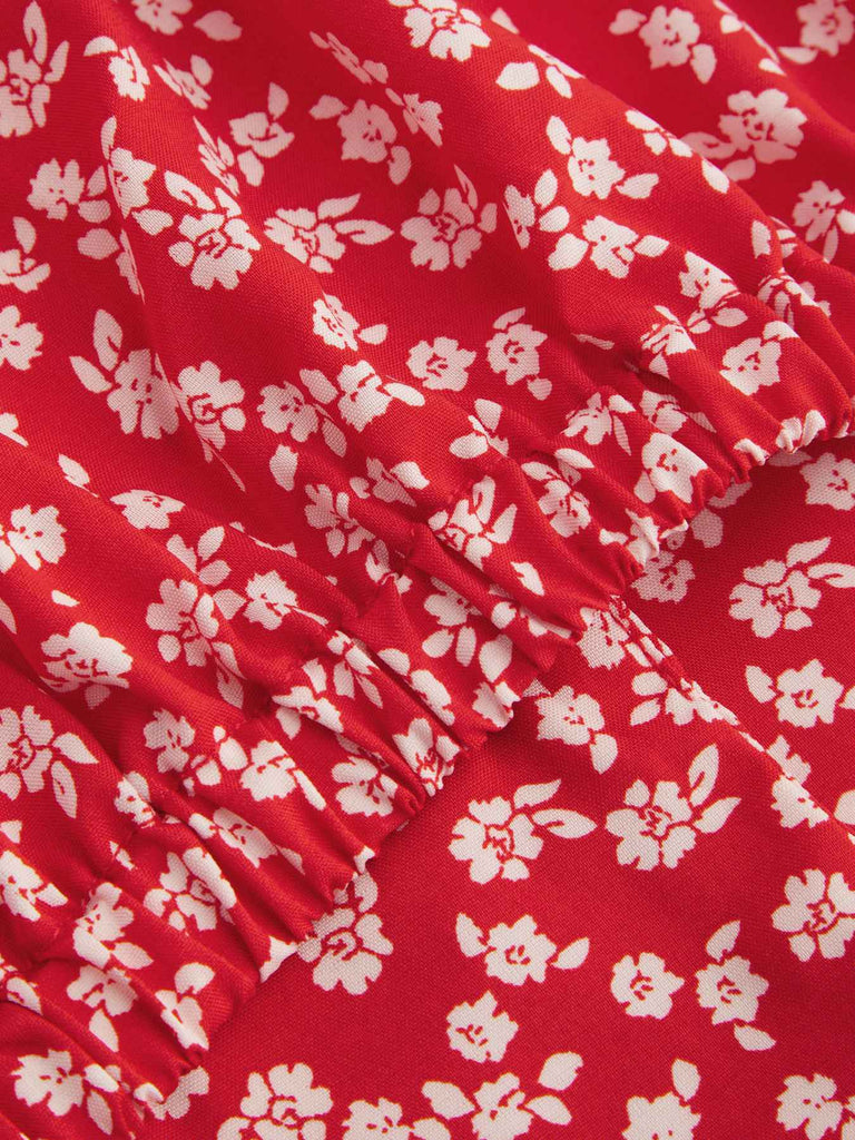 Chemisier rouge à fleurs à revers avec nœud des années 1950