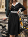 Robe noire et blanche à revers, col V et manches longues années 1950