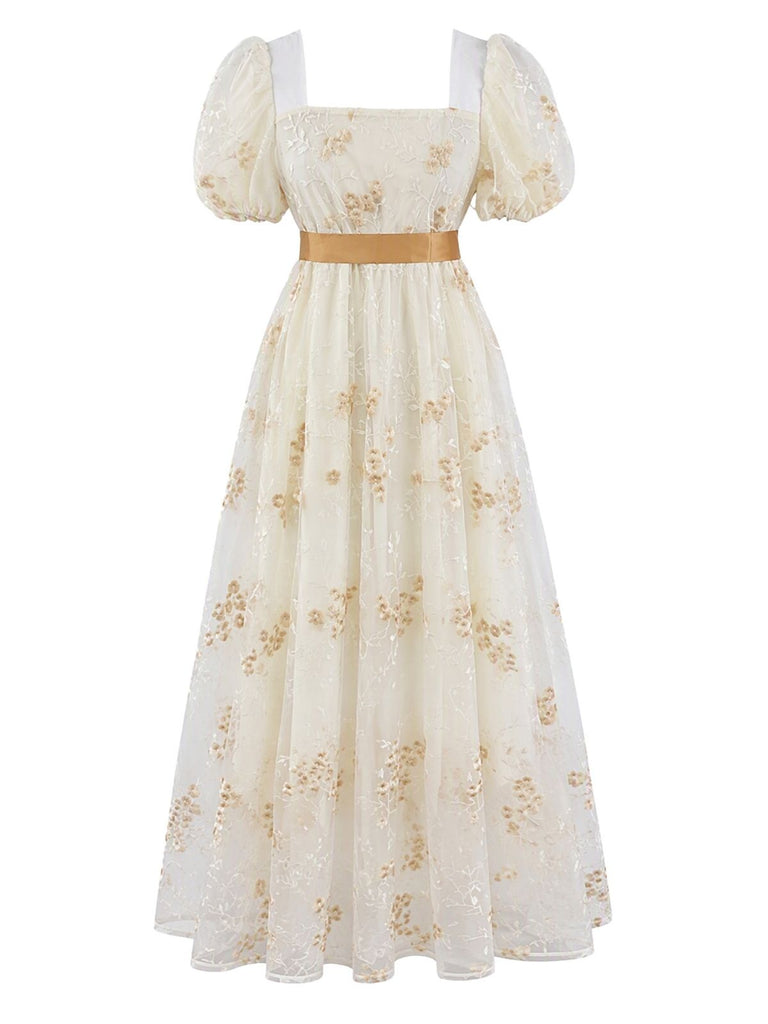 Robe longue à fleurs brodées, nœud et manches bouffantes années 1970