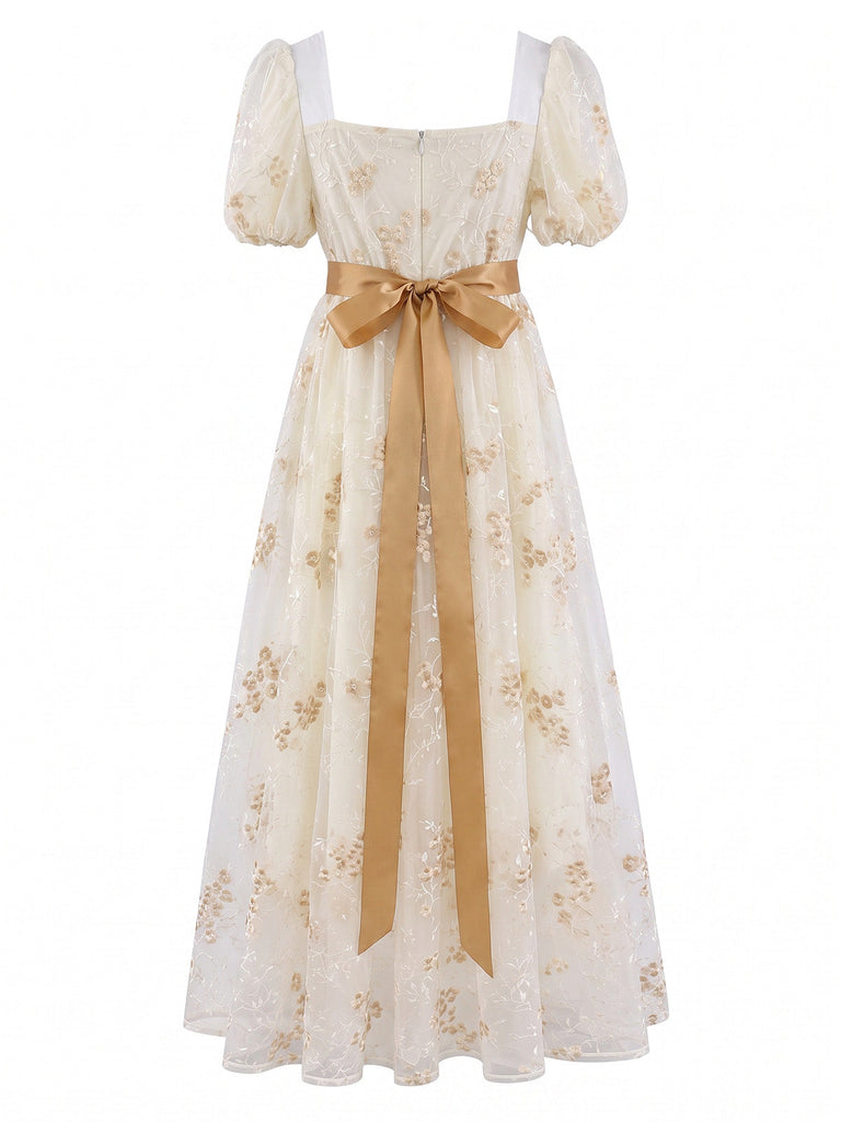Robe longue à fleurs brodées, nœud et manches bouffantes années 1970