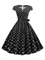 Robe ceinturée à pois et manches capes des années 1950