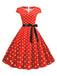 Robe ceinturée à pois et manches capes des années 1950