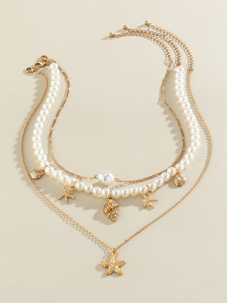Collier chaîne superposée en perles coquillages et étoiles de mer