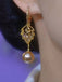 Boucles d'oreilles pendantes dorées à feuilles, strass et perles