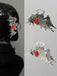 Pince à cheveux métallique gothique ailes de chauve-souris avec gemme rouge