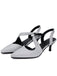 Pair of silver glittery kitten heel shoes on a white background