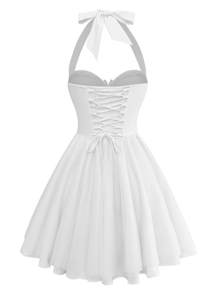 White halter-neck dress with lace-up front on a white background