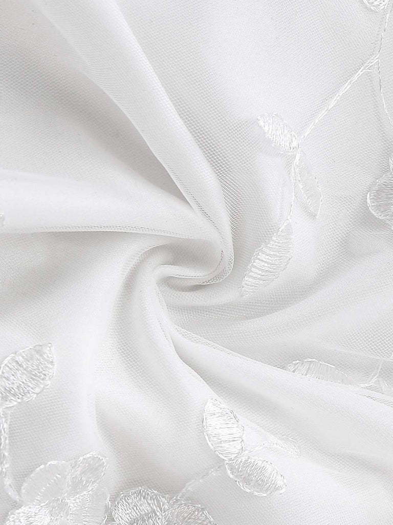 White vintage dress with floral embroidered lace and square neckline in 1950s retro style
