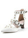 White shoe with decorative straps and buckles on a white background