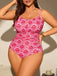 Woman wearing a pink and red patterned swimsuit against a neutral background