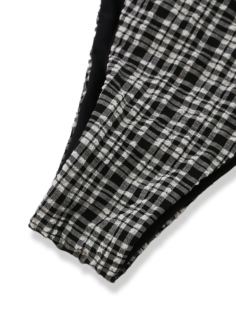 Close-up of a black and white checkered fabric with a frayed edge on a white background