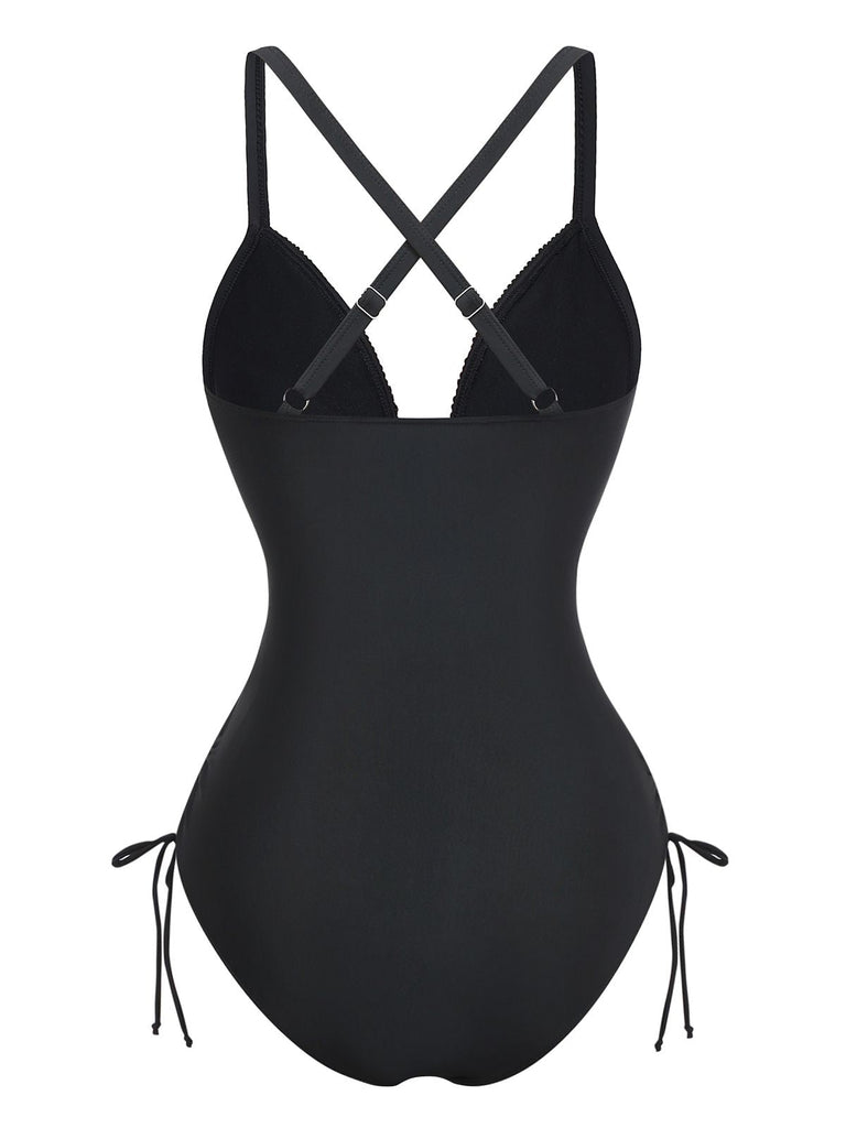 Rear view of the black one-piece swimsuit highlighting the elegant cross-back strap design and full coverage bottom.