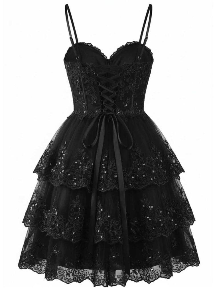 Angled view of the black version of the lace mini dress showcasing the volume of the tiered layers.