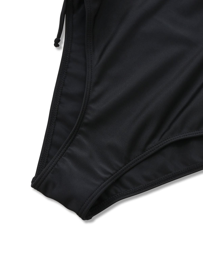 Close-up of the elastic leg opening and high-quality stitching on the black swimwear.