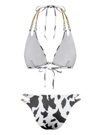 Back view of the black and white cow print bikini showcasing the tie closures and gold chain strap detailing.