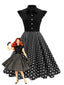 Robe noire trapèze à pois col nœud manches cape années 1950