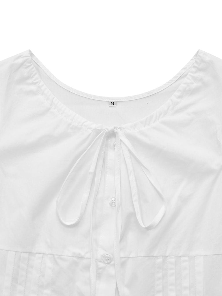 Close-up of the charming bow tie neckline and soft gathered fabric on the bodice of the white retro shirt.