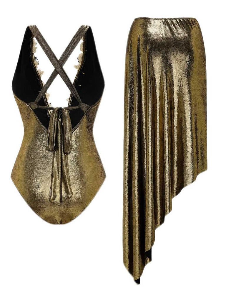 Rear view of the gold swimsuit showcasing the criss-cross back straps and the side-draped sarong.