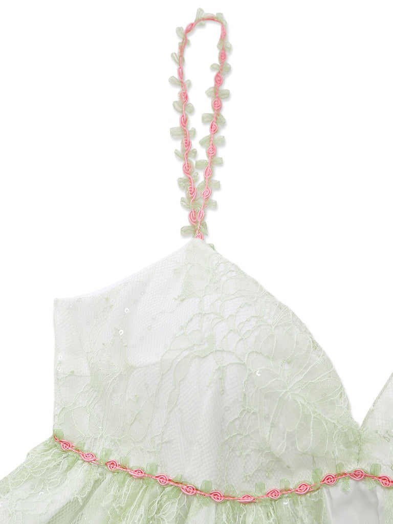 Light green nightdress with pink rose-strap on a white background