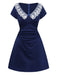 A three-quarter view of the navy blue short-sleeve vintage flare dress showing the flattering ruched waistline.