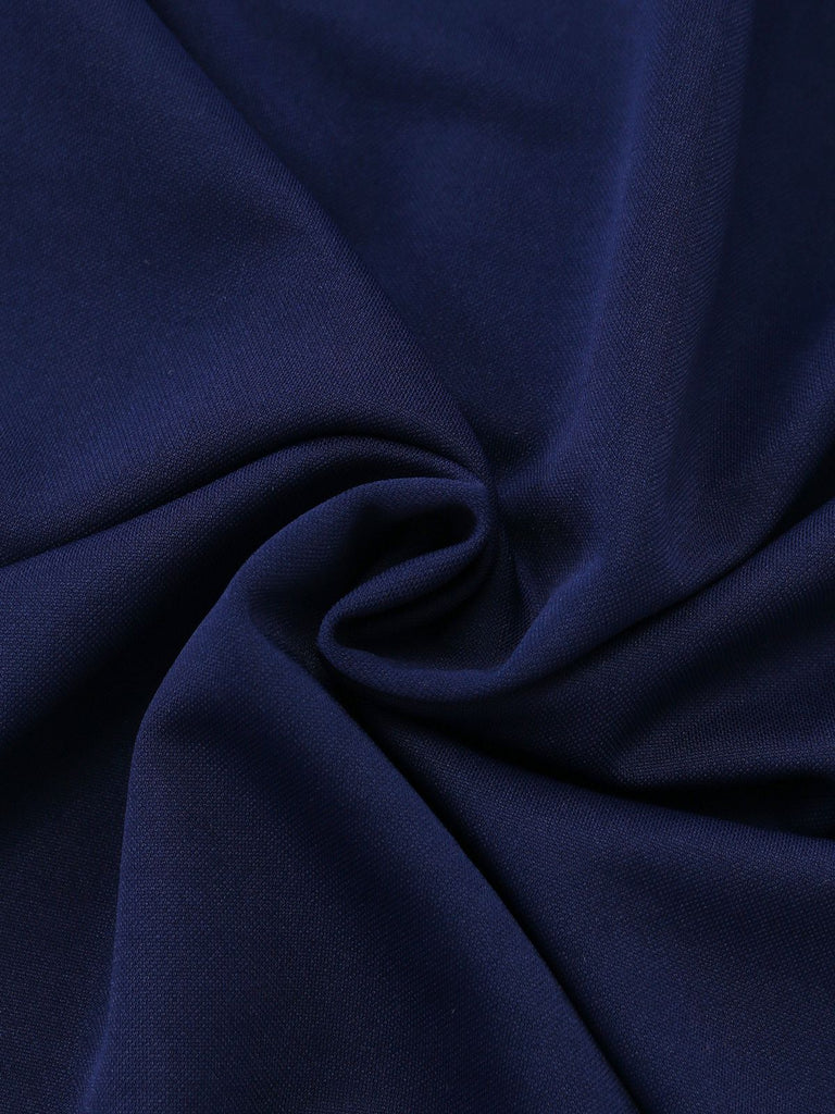 Macro view of the navy blue fabric texture, highlighting its soft, smooth, and slightly stretchy quality.